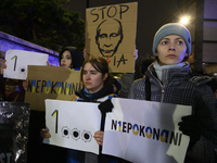 People hold placards and signs that read ''Stop Russia'' and ''Unbeatable'' as they rally on the 1000th day of Russian aggression on Ukraine...