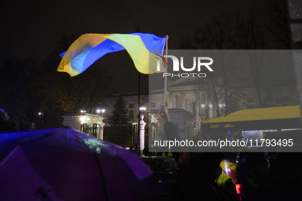 Demonstrators wave Ukrainian flags outside the Russian Federation embassy as they rally on the 1000th day of Russian aggression on Ukraine i...