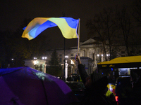 Demonstrators wave Ukrainian flags outside the Russian Federation embassy as they rally on the 1000th day of Russian aggression on Ukraine i...