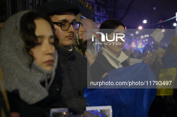 People hold signs and flags of Ukraine as they rally on the 1000th day of Russian aggression on Ukraine in Warsaw, Poland, on November 19, 2...