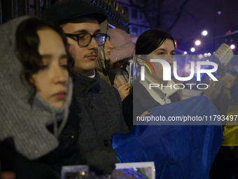 People hold signs and flags of Ukraine as they rally on the 1000th day of Russian aggression on Ukraine in Warsaw, Poland, on November 19, 2...