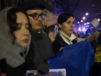 People hold signs and flags of Ukraine as they rally on the 1000th day of Russian aggression on Ukraine in Warsaw, Poland, on November 19, 2...