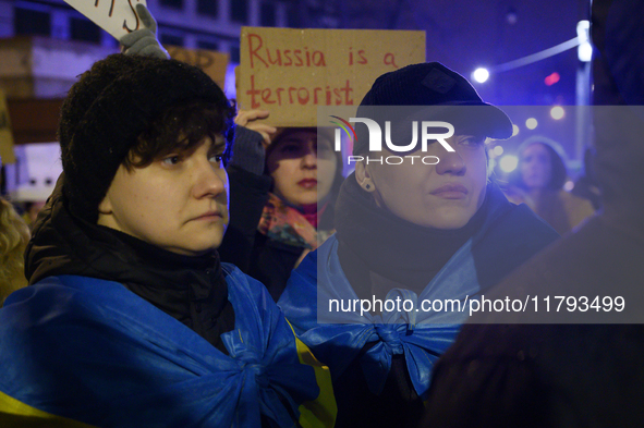 People hold signs and flags of Ukraine as they rally on the 1000th day of Russian aggression on Ukraine in Warsaw, Poland, on November 19, 2...