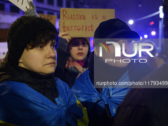 People hold signs and flags of Ukraine as they rally on the 1000th day of Russian aggression on Ukraine in Warsaw, Poland, on November 19, 2...