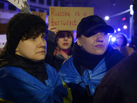 People hold signs and flags of Ukraine as they rally on the 1000th day of Russian aggression on Ukraine in Warsaw, Poland, on November 19, 2...