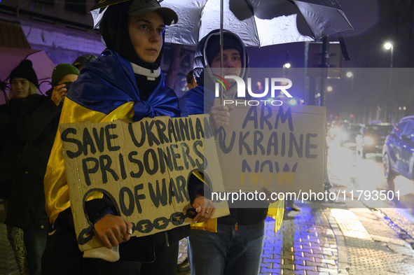 People hold signs that read ''Save Ukrainian Prisoners of War'' and ''Arm Ukraine Now'' as they rally on the 1000th day of Russian aggressio...