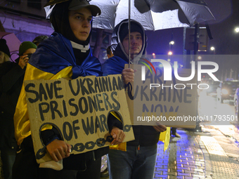 People hold signs that read ''Save Ukrainian Prisoners of War'' and ''Arm Ukraine Now'' as they rally on the 1000th day of Russian aggressio...