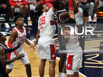 Maozinha Pereira #25 and Miles Norris #8 of the Memphis Hustle block Warith Alatishe #55 of the Texas Legends' shot during the NBA G League...