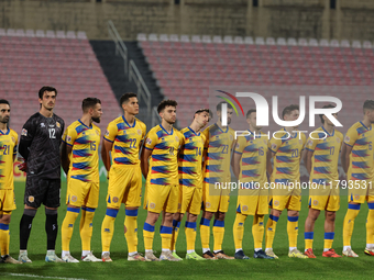 In Ta' Qali, Malta, on November 19, 2024, Andorra soccer national team players stand during the playing of their country's national anthem p...