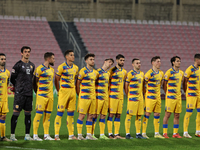 In Ta' Qali, Malta, on November 19, 2024, Andorra soccer national team players stand during the playing of their country's national anthem p...