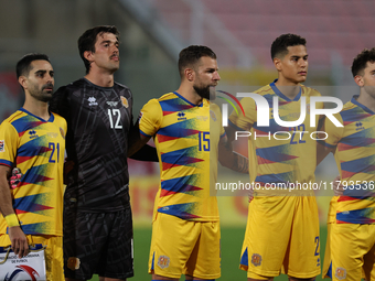 In Ta' Qali, Malta, on November 19, 2024, Andorra soccer national team players stand during the playing of their country's national anthem p...