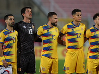 In Ta' Qali, Malta, on November 19, 2024, Andorra soccer national team players stand during the playing of their country's national anthem p...