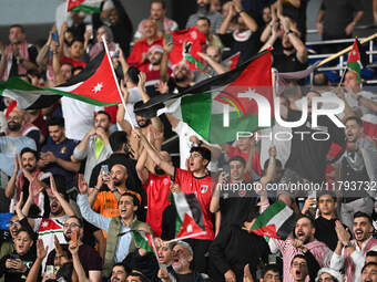 Soccer fans cheer during the AFC Asian Qualifiers Road to 26 match between Kuwait and Jordan in Kuwait City, Kuwait, on November 19, 2024, a...