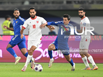 Mohammad Abdullah of Kuwait competes against Mousa Altamari of Jordan during the AFC Asian Qualifiers Road to 26 match between Kuwait and Jo...