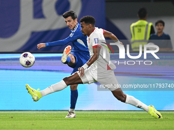 Mohammad Abdullah of Kuwait competes against Abdallah Nasib of Jordan during the AFC Asian Qualifiers Road to 26 match between Kuwait and Jo...