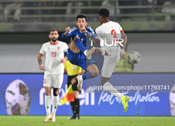 Mohammad Abdullah of Kuwait competes against Abdallah Nasib of Jordan during the AFC Asian Qualifiers Road to 26 match between Kuwait and Jo...