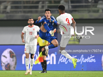 Mohammad Abdullah of Kuwait competes against Abdallah Nasib of Jordan during the AFC Asian Qualifiers Road to 26 match between Kuwait and Jo...