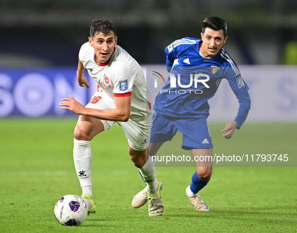 Mohammad Abdullah of Kuwait competes against Mohammad Abualnadi of Jordan during the AFC Asian Qualifiers Road to 26 match between Kuwait an...