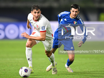 Mohammad Abdullah of Kuwait competes against Mohammad Abualnadi of Jordan during the AFC Asian Qualifiers Road to 26 match between Kuwait an...