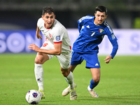 Mohammad Abdullah of Kuwait competes against Mohammad Abualnadi of Jordan during the AFC Asian Qualifiers Road to 26 match between Kuwait an...