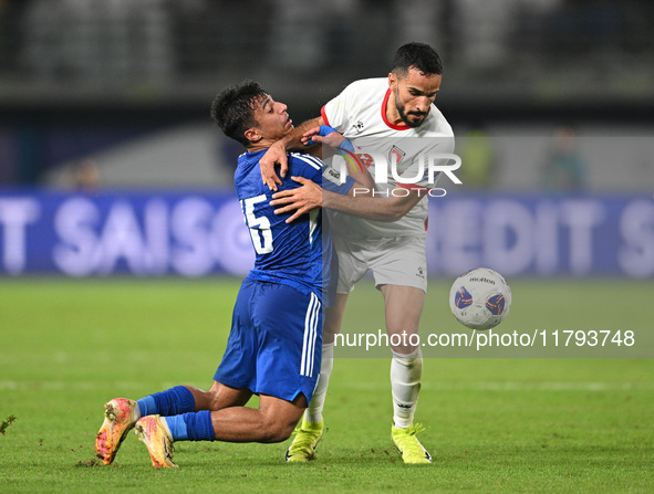 Yosef Alshammari of Kuwait competes against Mahmoud Almardi of Jordan during the AFC Asian Qualifiers Road to 26 match between Kuwait and Jo...