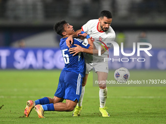 Yosef Alshammari of Kuwait competes against Mahmoud Almardi of Jordan during the AFC Asian Qualifiers Road to 26 match between Kuwait and Jo...