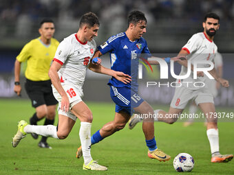 Yosef Alshammari of Kuwait competes against Mohammad Abualnadi of Jordan during the AFC Asian Qualifiers Road to 26 match between Kuwait and...