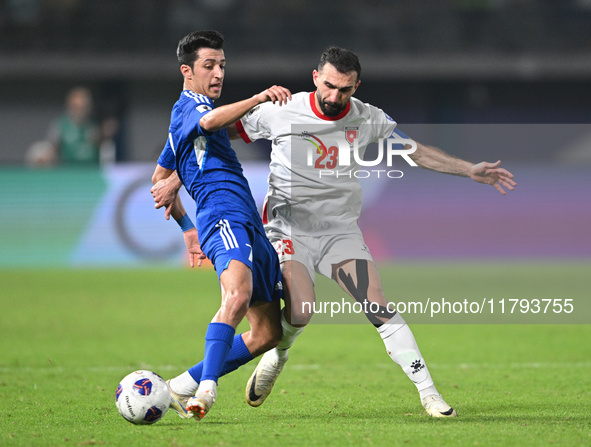 Mohammad Abdullah of Kuwait competes against Ehsan Haddad of Jordan during the AFC Asian Qualifiers Road to 26 match between Kuwait and Jord...