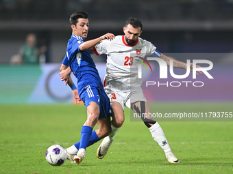 Mohammad Abdullah of Kuwait competes against Ehsan Haddad of Jordan during the AFC Asian Qualifiers Road to 26 match between Kuwait and Jord...