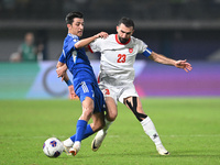 Mohammad Abdullah of Kuwait competes against Ehsan Haddad of Jordan during the AFC Asian Qualifiers Road to 26 match between Kuwait and Jord...