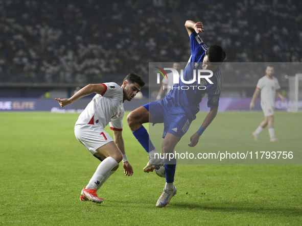 Mohammad Abdullah of Kuwait competes against Yawed Abulaila of Jordan during the AFC Asian Qualifiers Road to 26 match between Kuwait and Jo...