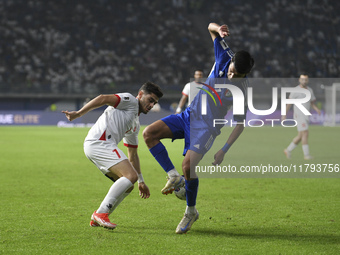 Mohammad Abdullah of Kuwait competes against Yawed Abulaila of Jordan during the AFC Asian Qualifiers Road to 26 match between Kuwait and Jo...