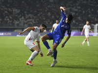 Mohammad Abdullah of Kuwait competes against Yawed Abulaila of Jordan during the AFC Asian Qualifiers Road to 26 match between Kuwait and Jo...