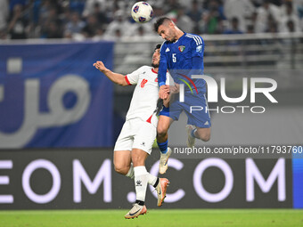 Fahad Alhajeri of Kuwait competes against Resin Mohammed Banihani of Jordan during the AFC Asian Qualifiers Road to 26 match between Kuwait...