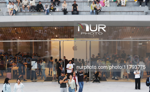 Customers shop at the largest Apple flagship store in Asia in Shanghai, China, on September 22, 2024. 