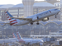 American Airlines Boeing 737 MAX 8 passenger aircraft spotted during takeoff and flying in front of the airport terminal, air traffic contro...