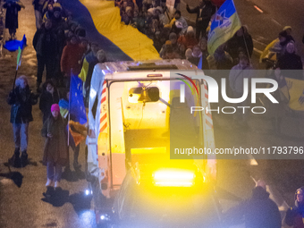 A destroyed medical vehicle is displayed as two hundred people march in silence to mark 1000 days since the full-scale war between Ukraine a...