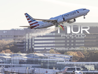 American Airlines Boeing 737 MAX 8 passenger aircraft spotted during takeoff and flying in front of the airport terminal, air traffic contro...