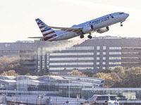 American Airlines Boeing 737 MAX 8 passenger aircraft spotted during takeoff and flying in front of the airport terminal, air traffic contro...