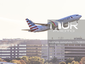 American Airlines Boeing 737 MAX 8 passenger aircraft spotted during takeoff and flying in front of the airport terminal, air traffic contro...