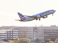 American Airlines Boeing 737 MAX 8 passenger aircraft spotted during takeoff and flying in front of the airport terminal, air traffic contro...