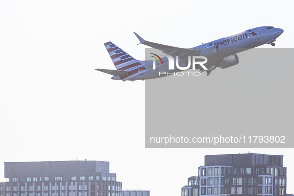 American Airlines Boeing 737 MAX 8 passenger aircraft spotted during takeoff and flying in front of the airport terminal, air traffic contro...