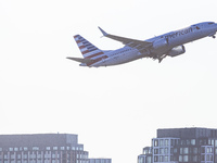 American Airlines Boeing 737 MAX 8 passenger aircraft spotted during takeoff and flying in front of the airport terminal, air traffic contro...