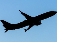 Silhouette of a Boeing 737 MAX8 passing in front of the sun during the flight. American Airlines Boeing 737 MAX 8 passenger aircraft spotted...