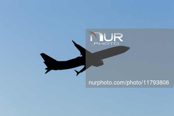 Silhouette of a Boeing 737 MAX8 passing in front of the sun during the flight. American Airlines Boeing 737 MAX 8 passenger aircraft spotted...