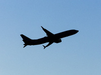 Silhouette of a Boeing 737 MAX8 passing in front of the sun during the flight. American Airlines Boeing 737 MAX 8 passenger aircraft spotted...