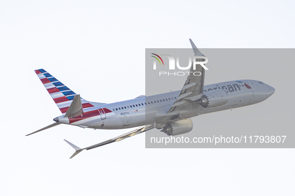 American Airlines Boeing 737 MAX 8 passenger aircraft spotted during takeoff and flying in front of the airport terminal, air traffic contro...