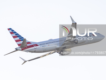 American Airlines Boeing 737 MAX 8 passenger aircraft spotted during takeoff and flying in front of the airport terminal, air traffic contro...