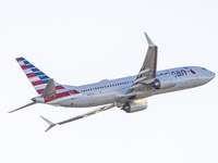 American Airlines Boeing 737 MAX 8 passenger aircraft spotted during takeoff and flying in front of the airport terminal, air traffic contro...