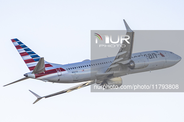 American Airlines Boeing 737 MAX 8 passenger aircraft spotted during takeoff and flying in front of the airport terminal, air traffic contro...